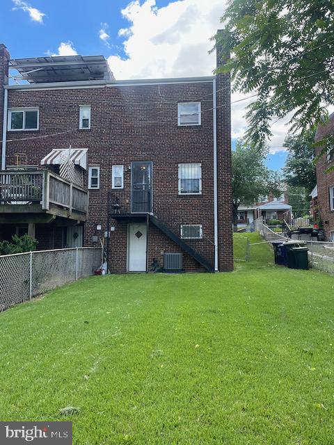 3936 NE Blaine St NE, Washington, DC 20019 - rear view of house with cooling unit, brick siding, and stairway
