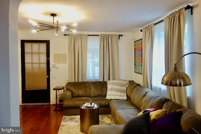 3936 NE Blaine St NE, Washington, DC 20019 - living room featuring healthy amount of natural light, a chandelier, and wood finished floors