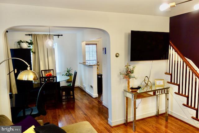 3936 NE Blaine St NE, Washington, DC 20019 - living area with wood finished floors, arched walkways, stairs, and baseboards