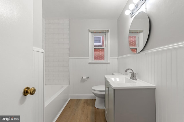 509 W Cork St, Winchester, VA 22601 - bathroom with toilet, vanity, wood finished floors, wainscoting, and bathing tub / shower combination