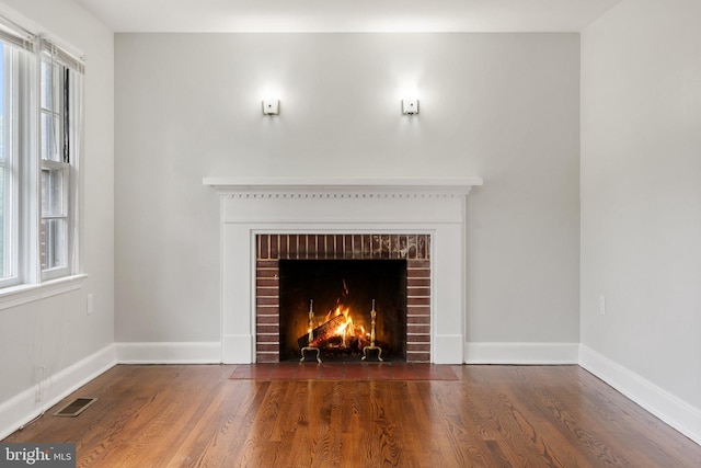 509 W Cork St, Winchester, VA 22601 - detailed view of wood finished floors, a fireplace, and baseboards