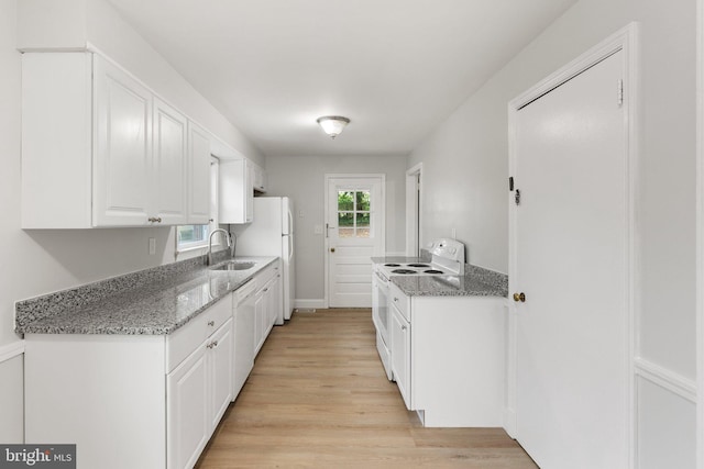 509 W Cork St, Winchester, VA 22601 - kitchen with white appliances, a sink, white cabinets, light wood-type flooring, and light stone countertops