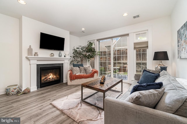 3209 Haley Way, Mechanicsburg, PA 17055 - living room featuring light wood finished floors, recessed lighting, a glass covered fireplace, and baseboards