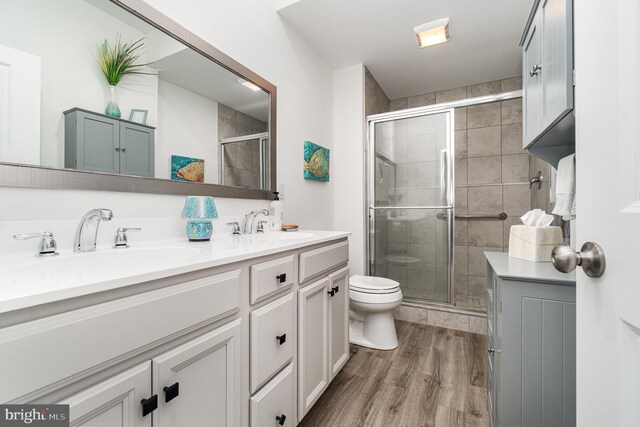 3209 Haley Way, Mechanicsburg, PA 17055 - bathroom with double vanity, toilet, a shower stall, and wood finished floors