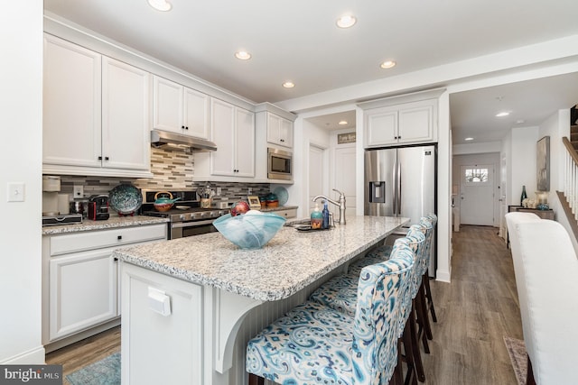 3209 Haley Way, Mechanicsburg, PA 17055 - kitchen with appliances with stainless steel finishes, under cabinet range hood, light wood-type flooring, recessed lighting, and backsplash