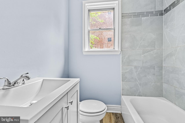 821 E Jeffrey St, Baltimore, MD 21225 - full bath featuring toilet, wood finished floors, baseboards, and vanity