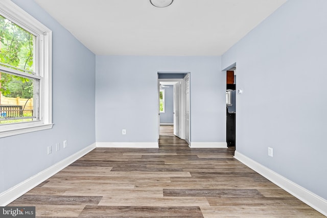 821 E Jeffrey St, Baltimore, MD 21225 - unfurnished room with plenty of natural light, baseboards, and wood finished floors