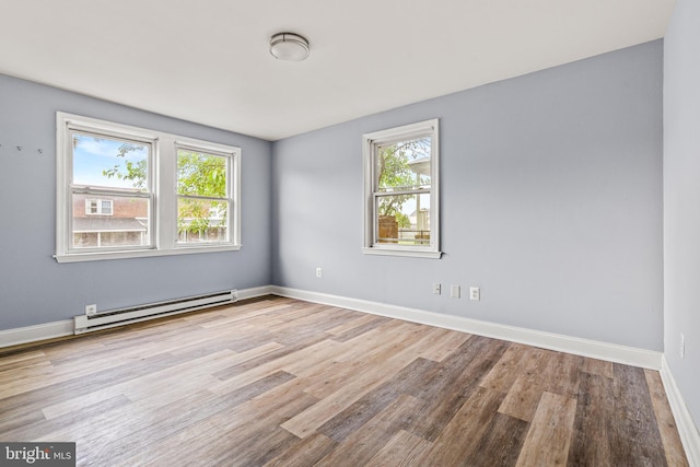 821 E Jeffrey St, Baltimore, MD 21225 - empty room featuring a baseboard radiator, wood finished floors, and baseboards