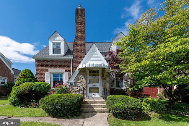 550 N 2nd St, Emmaus, PA 18049 - view of front facade featuring a chimney, a shingled roof, and brick siding