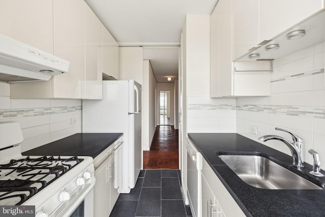 210 Locust St Unit 21Dw, Philadelphia, PA 19106 - kitchen featuring white appliances, a sink, under cabinet range hood, dark tile patterned floors, and tasteful backsplash