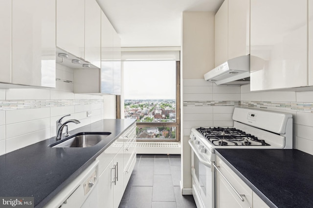 210 Locust St Unit 21Dw, Philadelphia, PA 19106 - kitchen featuring white appliances, under cabinet range hood, a sink, white cabinetry, and dark tile patterned floors