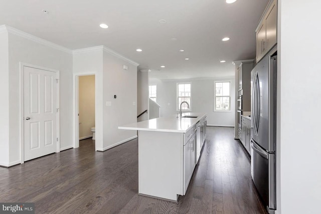 11 Blue Jay Way, Clarksburg, MD 20871 - kitchen with freestanding refrigerator, a sink, dark wood-style floors, a kitchen island with sink, and ornamental molding