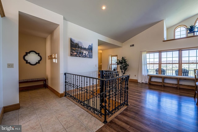 1874 Roundtop Rd, Wellsboro, PA 16901 - hallway with an upstairs landing, baseboards, healthy amount of natural light, wood finished floors, and high vaulted ceiling