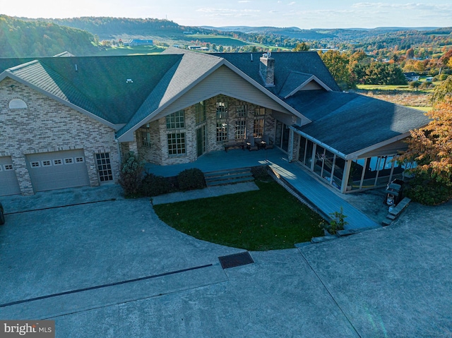1874 Roundtop Rd, Wellsboro, PA 16901 - view of front of property with stone siding, driveway, an attached garage, and a chimney