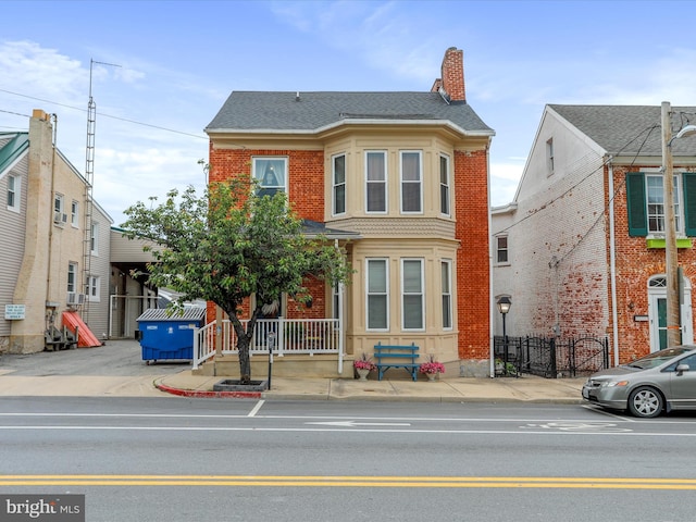 25 E Potomac St, Williamsport, MD 21795 - multi unit property featuring a chimney, brick siding, and a shingled roof