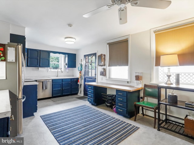 25 E Potomac St, Williamsport, MD 21795 - kitchen with stainless steel appliances, blue cabinets, light countertops, ceiling fan, and a sink