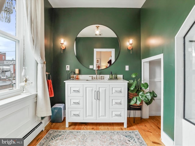 25 E Potomac St, Williamsport, MD 21795 - bathroom featuring wood finished floors, vanity, and a baseboard heating unit