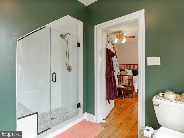 25 E Potomac St, Williamsport, MD 21795 - full bathroom with hardwood / wood-style flooring, a stall shower, toilet, and a ceiling fan