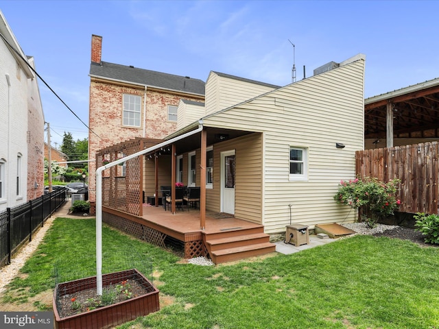 25 E Potomac St, Williamsport, MD 21795 - rear view of house featuring a deck, a vegetable garden, and a chimney