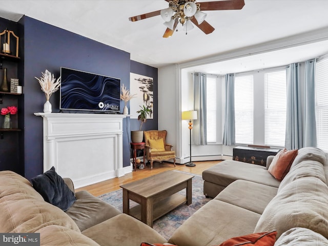 25 E Potomac St, Williamsport, MD 21795 - living room with wood finished floors, ceiling fan, and a baseboard radiator