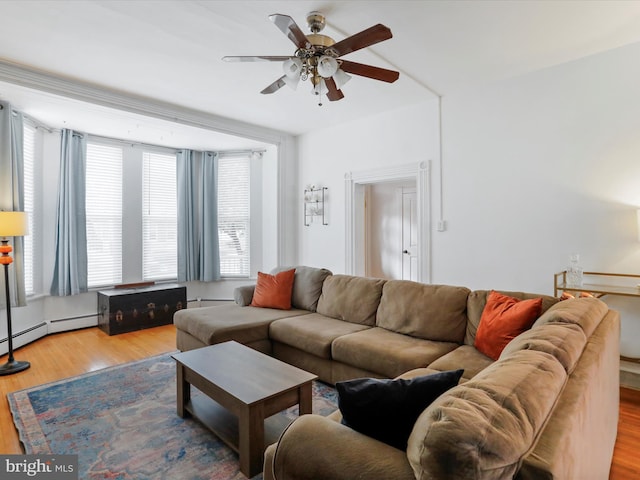 25 E Potomac St, Williamsport, MD 21795 - living area with a ceiling fan, wood finished floors, and a baseboard heating unit