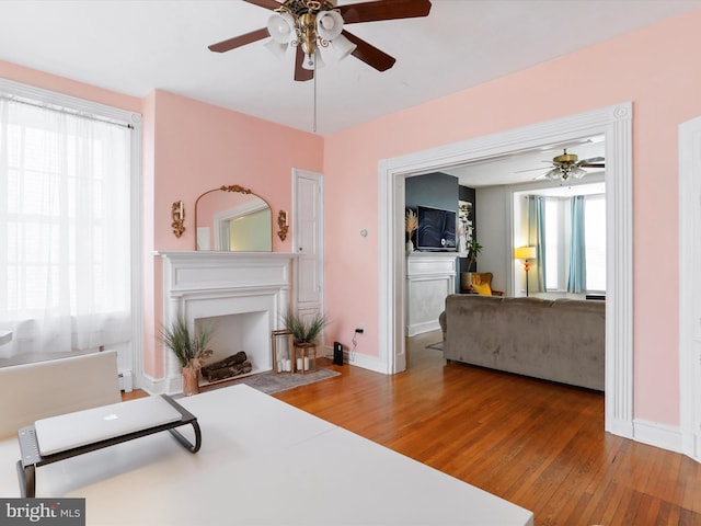 25 E Potomac St, Williamsport, MD 21795 - living room featuring ceiling fan, wood-type flooring, healthy amount of natural light, and a fireplace with flush hearth