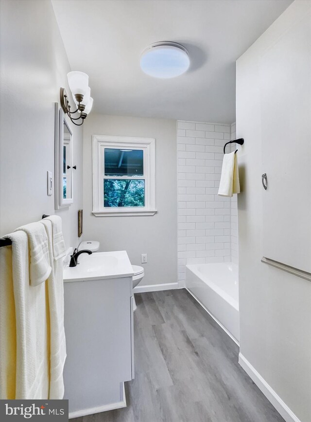 6985 Old Harrisburg Rd, York Springs, PA 17372 - full bathroom featuring vanity, wood finished floors, baseboards, toilet, and  shower combination