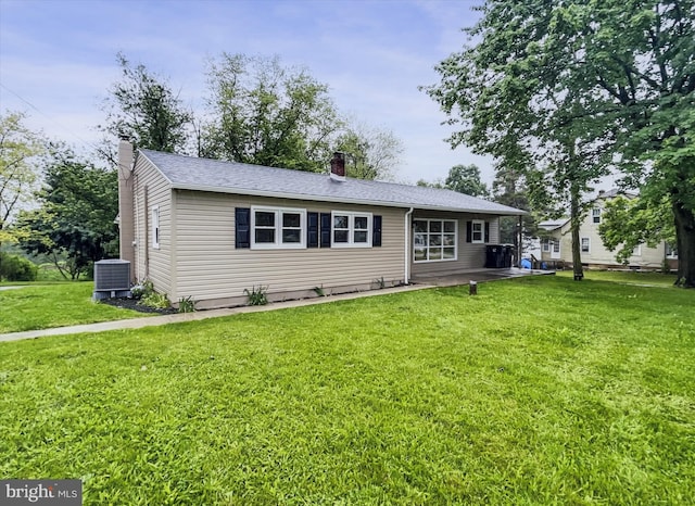 6985 Old Harrisburg Rd, York Springs, PA 17372 - view of front facade featuring a chimney, central AC unit, and a front yard