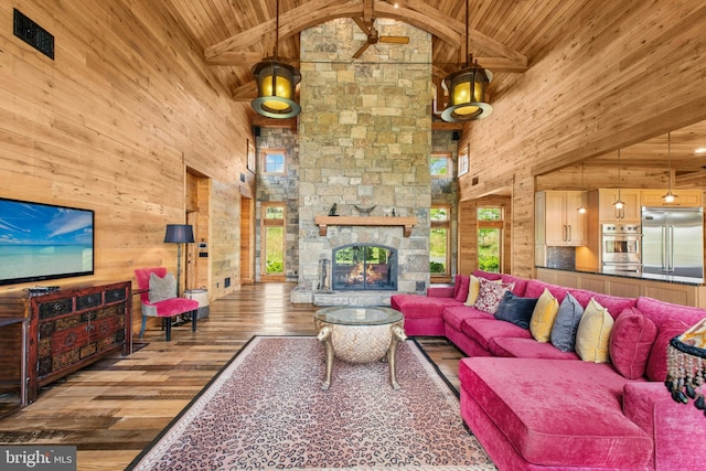2042 Folk Rd, Fogelsville, PA 18051 - living area featuring wood ceiling with exposed beams, high vaulted ceiling, wood walls, plenty of natural light, and wood finished floors