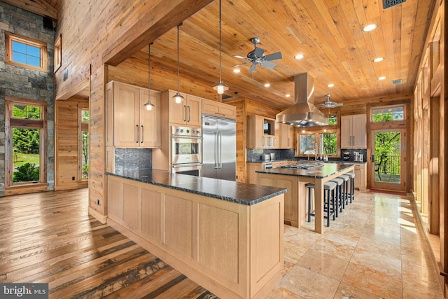 2042 Folk Rd, Fogelsville, PA 18051 - kitchen featuring stainless steel appliances, island range hood, wood ceiling, recessed lighting, and a peninsula
