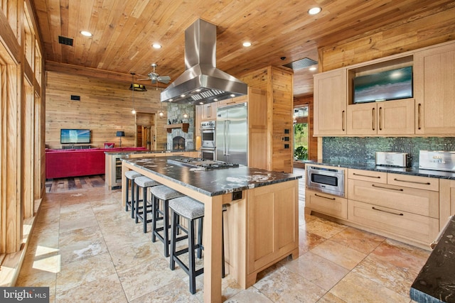 2042 Folk Rd, Fogelsville, PA 18051 - kitchen with island range hood, built in appliances, light brown cabinetry, dark countertops, and wooden ceiling