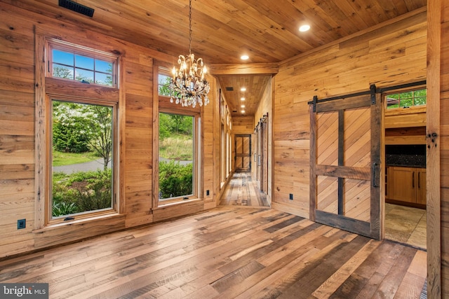 2042 Folk Rd, Fogelsville, PA 18051 - spare room with a barn door, wood-type flooring, wood ceiling, wooden walls, and recessed lighting