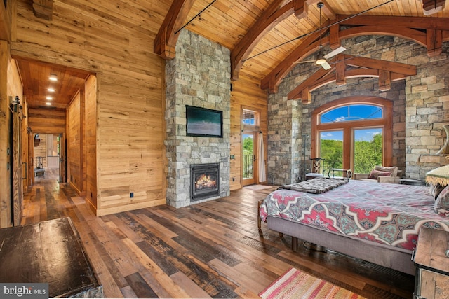 2042 Folk Rd, Fogelsville, PA 18051 - bedroom featuring hardwood / wood-style floors, wooden ceiling with exposed beams, an outdoor stone fireplace, high vaulted ceiling, and wooden walls