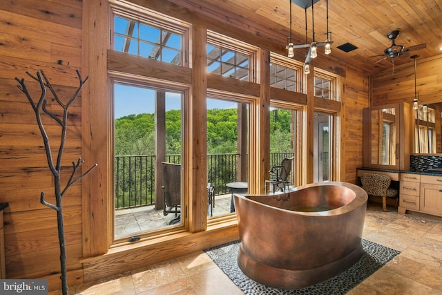 2042 Folk Rd, Fogelsville, PA 18051 - entryway featuring wooden ceiling, stone tile floors, wooden walls, a towering ceiling, and ceiling fan