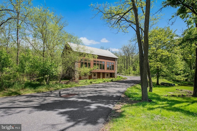 2042 Folk Rd, Fogelsville, PA 18051 - view of front facade featuring a front yard, asphalt driveway, and metal roof