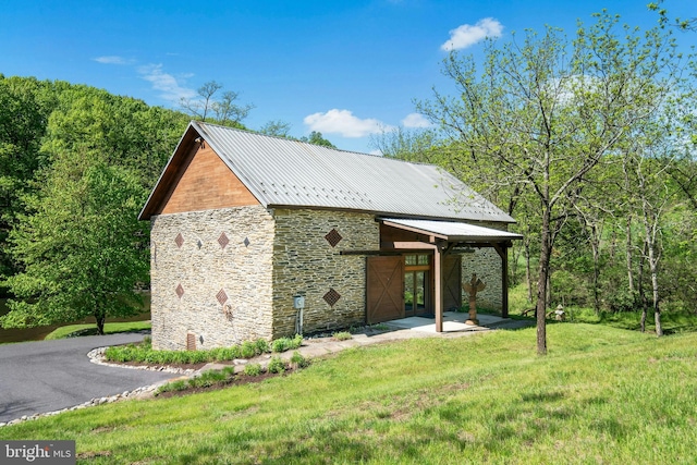 2042 Folk Rd, Fogelsville, PA 18051 - view of side of property featuring stone siding, a lawn, and metal roof