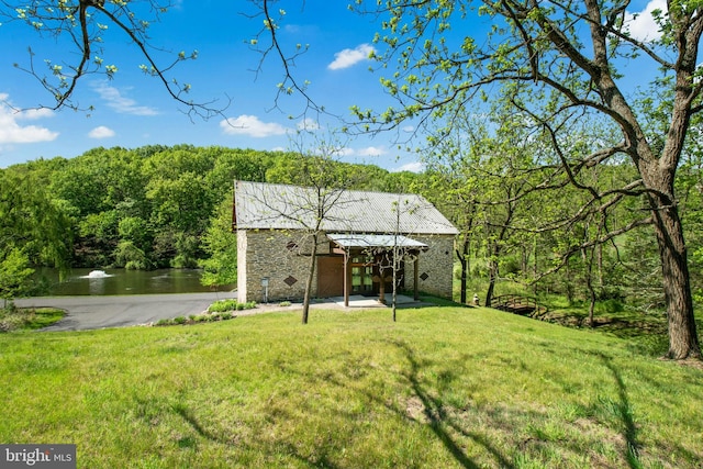 2042 Folk Rd, Fogelsville, PA 18051 - view of green lawn featuring a water view, a wooded view, and a patio