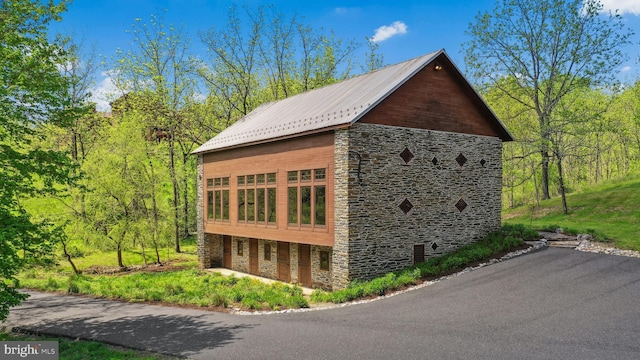 2042 Folk Rd, Fogelsville, PA 18051 - view of side of property featuring stone siding and metal roof