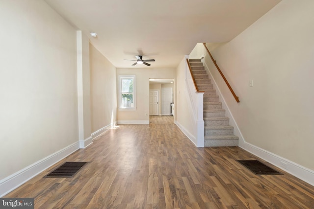 303 Coral St, Lancaster, PA 17603 - unfurnished living room featuring baseboards, stairs, wood finished floors, and a ceiling fan