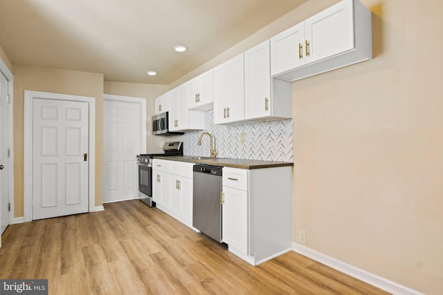 303 Coral St, Lancaster, PA 17603 - kitchen featuring appliances with stainless steel finishes, light wood finished floors, baseboards, white cabinetry, and recessed lighting