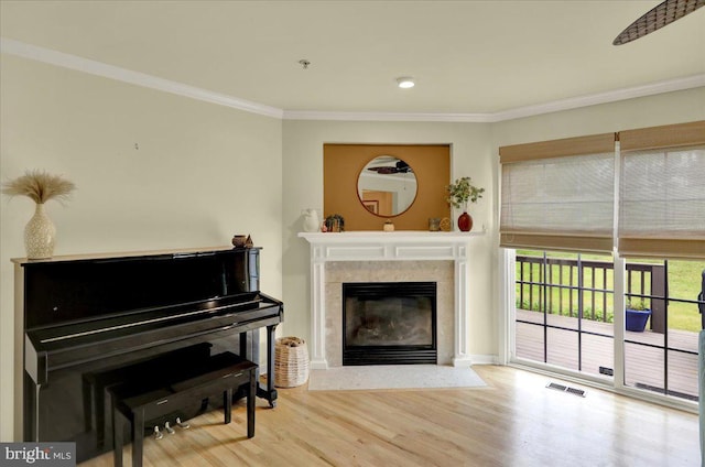 159 Waterford Ln, Reading, PA 19606 - living area with crown molding, wood finished floors, and a fireplace with flush hearth