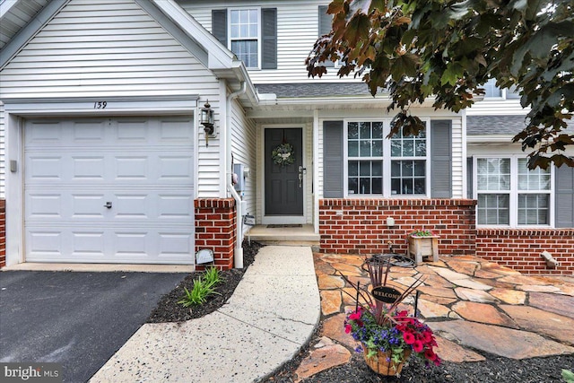 159 Waterford Ln, Reading, PA 19606 - entrance to property with brick siding, driveway, and a garage