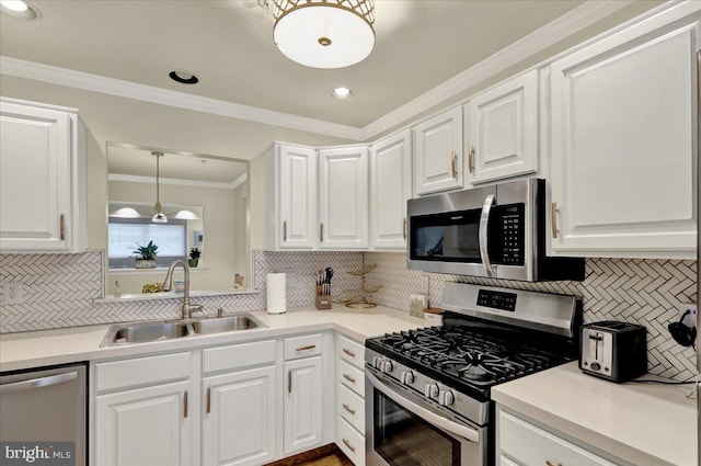 159 Waterford Ln, Reading, PA 19606 - kitchen featuring stainless steel appliances, a sink, decorative backsplash, white cabinetry, and ornamental molding