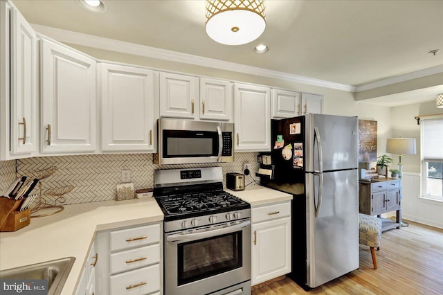 159 Waterford Ln, Reading, PA 19606 - kitchen with appliances with stainless steel finishes, white cabinets, backsplash, crown molding, and recessed lighting