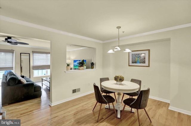 159 Waterford Ln, Reading, PA 19606 - dining room featuring light wood-style floors, baseboards, a chandelier, crown molding, and ceiling fan
