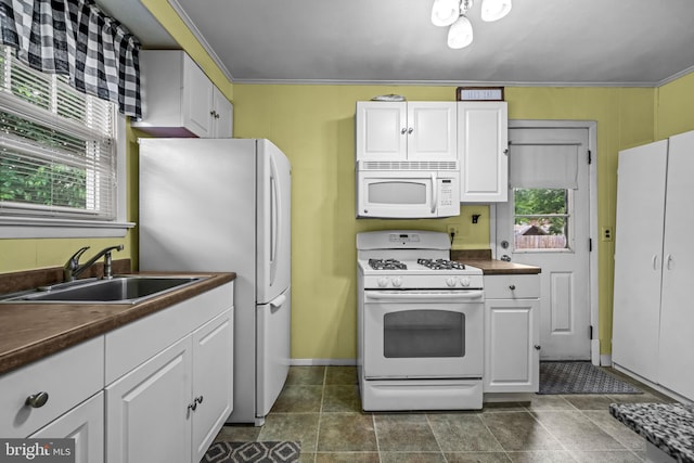 117 2nd Ave, Lindenwold, NJ 08021 - kitchen featuring white appliances, a sink, dark countertops, white cabinets, and baseboards