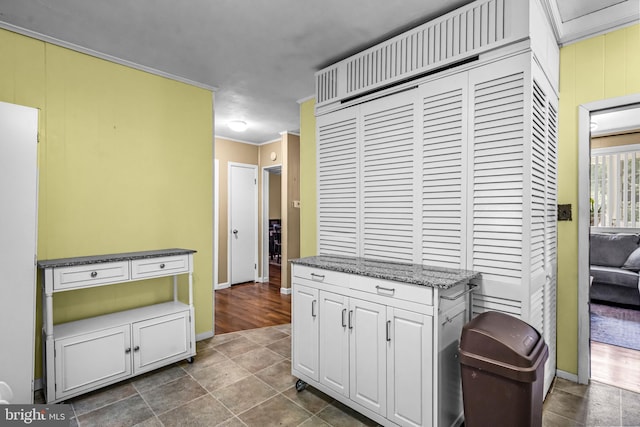117 2nd Ave, Lindenwold, NJ 08021 - kitchen with white cabinets, baseboards, stone counters, crown molding, and dark tile patterned flooring