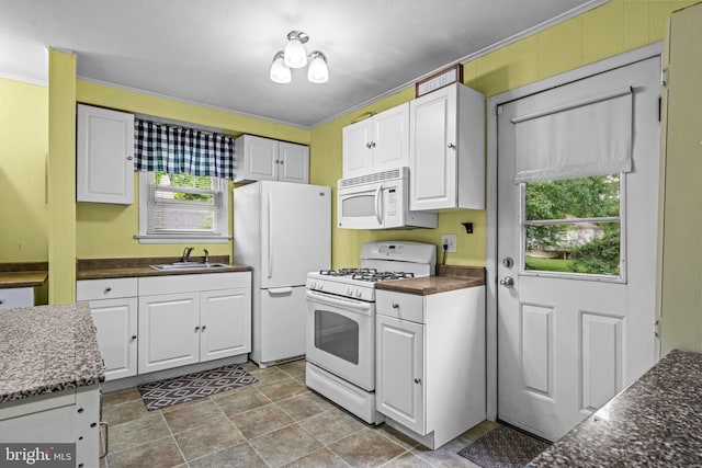 117 2nd Ave, Lindenwold, NJ 08021 - kitchen featuring white appliances, white cabinets, a sink, and stone finish flooring