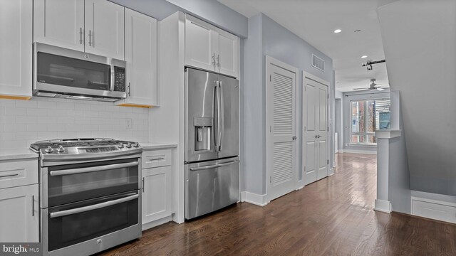 547 N 12th St Unit 2, Philadelphia, PA 19123 - kitchen featuring stainless steel appliances, ceiling fan, light countertops, baseboards, and white cabinets