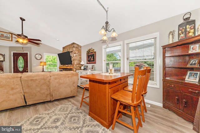 343 Mill Farm Trl, Berkeley Springs, WV 25411 - kitchen with lofted ceiling, a breakfast bar, light wood-type flooring, ceiling fan, and a chandelier